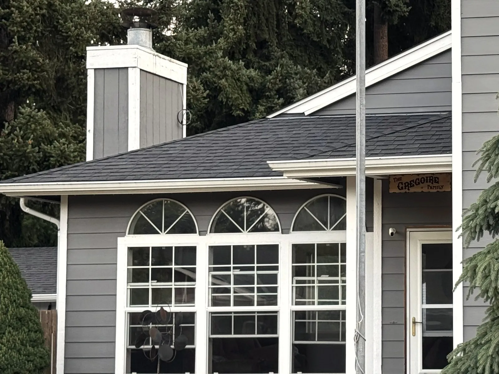 Gray siding and arched windows on a home finished by All Home HX