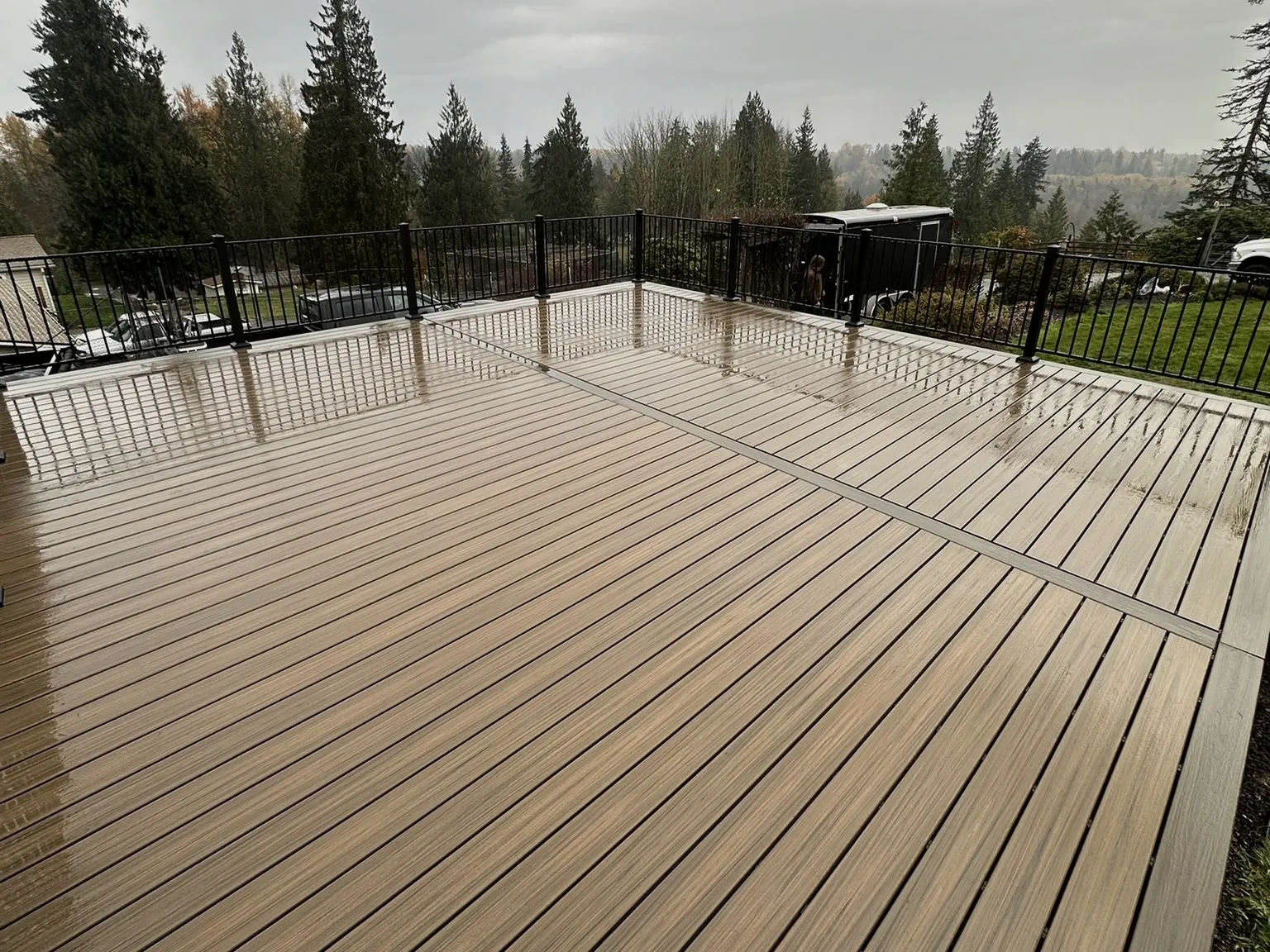 A large finished composite deck with black metal railing