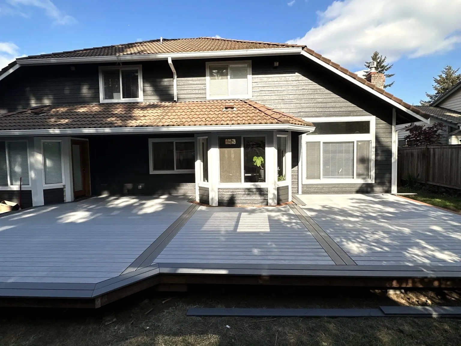 A whole-home exterior with a new deck, photographed on an All Home HX project